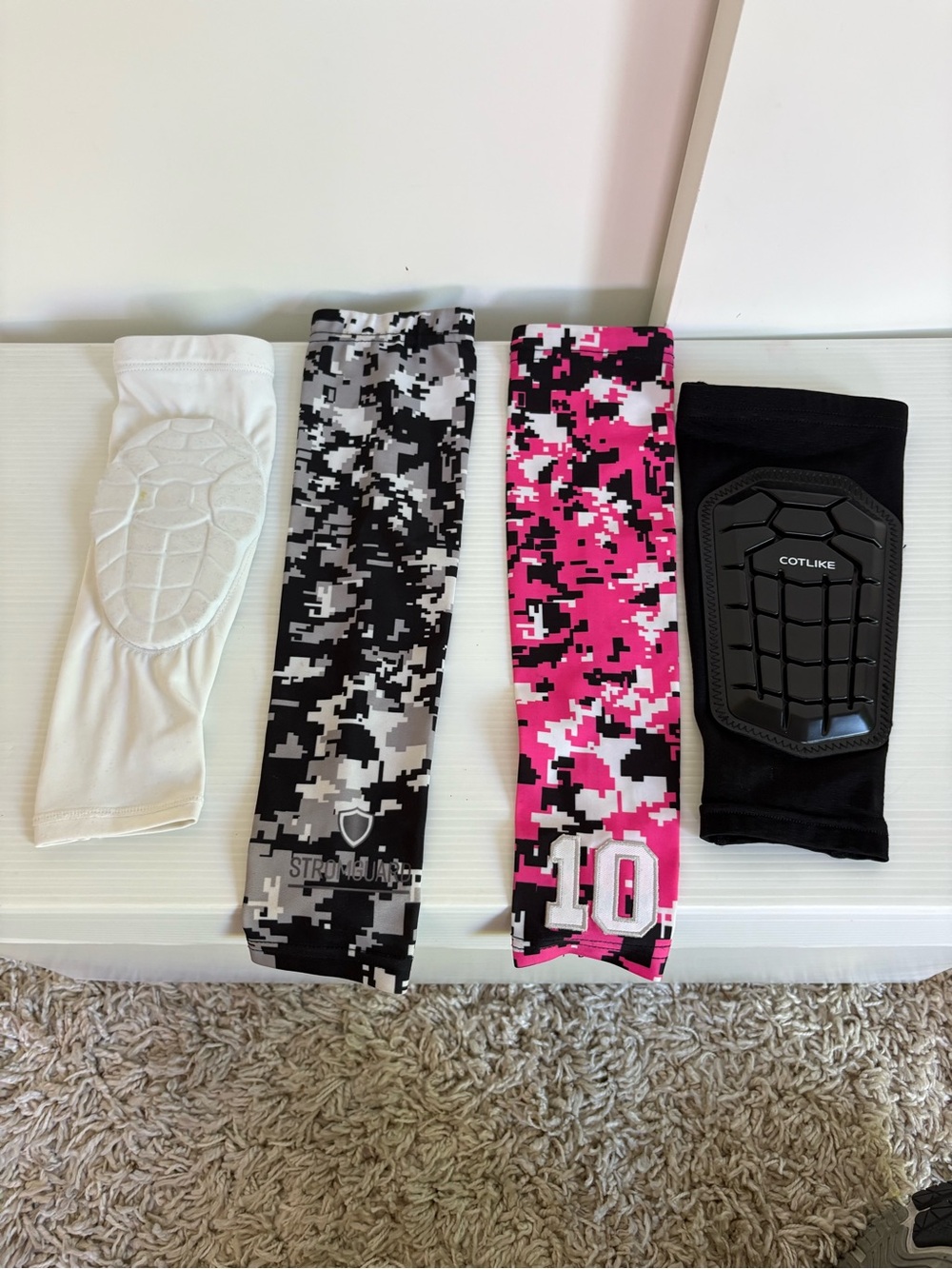 4  youth arm sleeves, (camo pink, camo black/ white, white and black)size sm/med